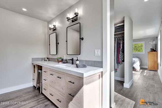 16111 E Nosey Ave, Talkeetna, AK 99676 - full bath with baseboards, double vanity, wood finished floors, a walk in closet, and recessed lighting