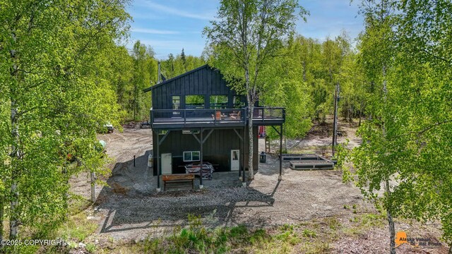 16111 E Nosey Ave, Talkeetna, AK 99676 - rear view of property with board and batten siding and a deck