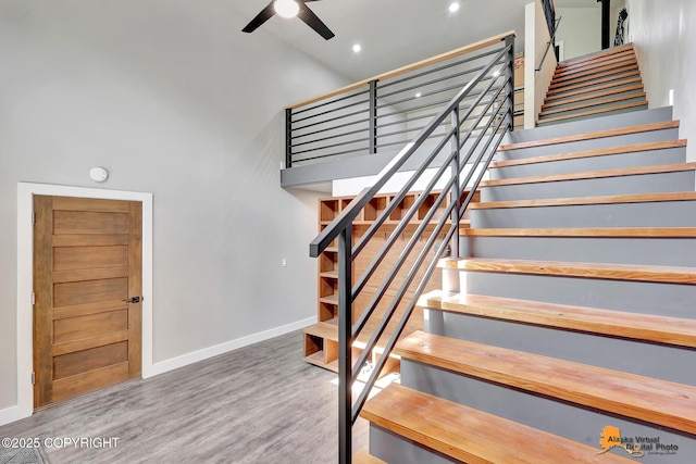 16111 E Nosey Ave, Talkeetna, AK 99676 - stairway with a towering ceiling, a ceiling fan, baseboards, wood finished floors, and recessed lighting