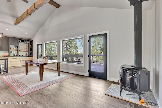 16111 E Nosey Ave, Talkeetna, AK 99676 - living area featuring a wood stove, beamed ceiling, light wood-style flooring, high vaulted ceiling, and baseboards