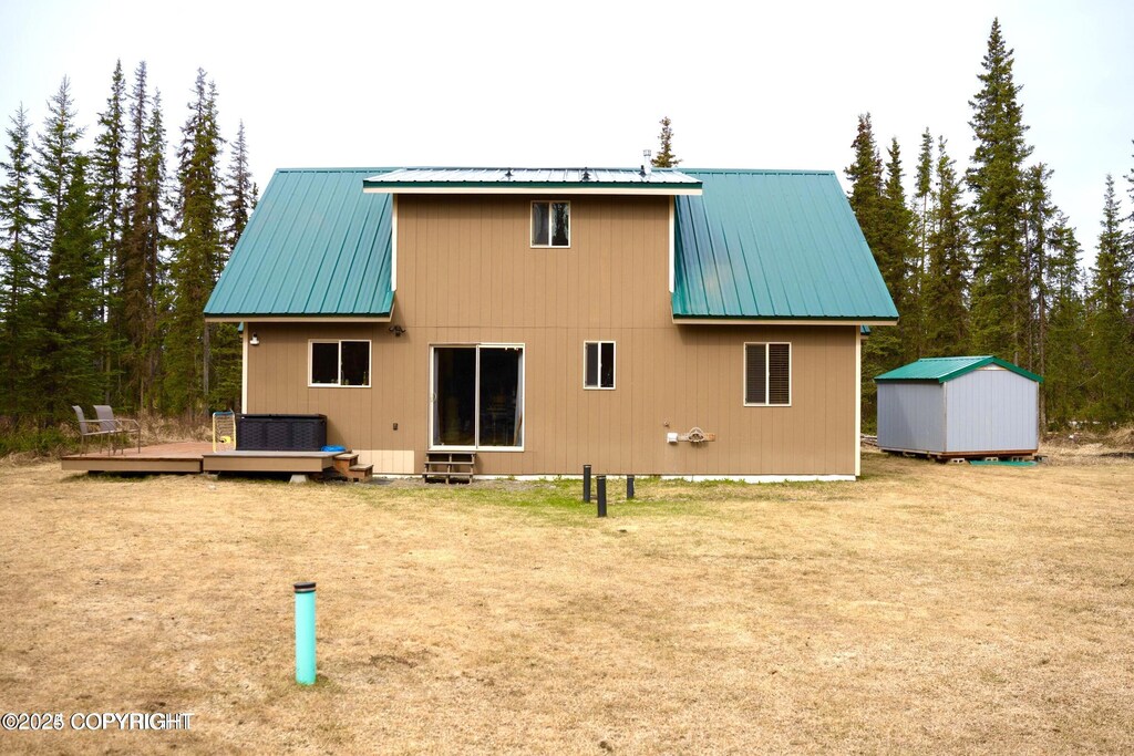 34540 Poppy Wood St, Soldotna, AK 99669 - rear view of property with a deck, metal roof, and a lawn