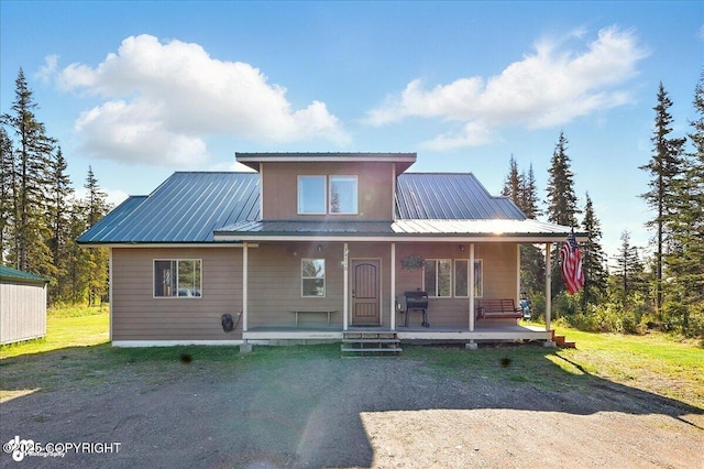 34540 Poppy Wood St, Soldotna, AK 99669 - farmhouse-style home featuring a porch and a metal roof