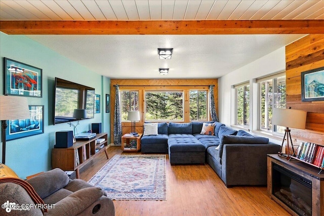 34540 Poppy Wood St, Soldotna, AK 99669 - living area featuring beam ceiling, light wood-style floors, and wooden walls