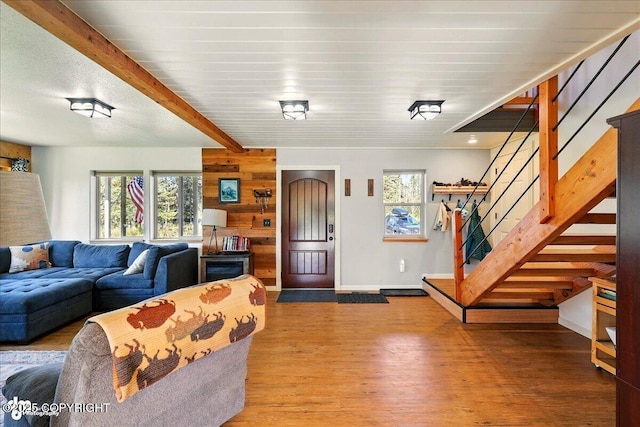 34540 Poppy Wood St, Soldotna, AK 99669 - living area featuring stairs, wood finished floors, beam ceiling, and wood walls