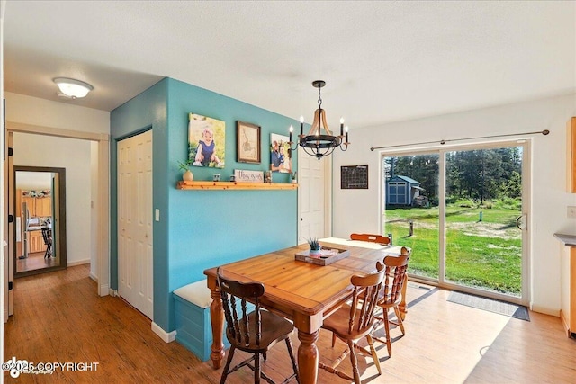 34540 Poppy Wood St, Soldotna, AK 99669 - dining area featuring a chandelier and light wood-style floors