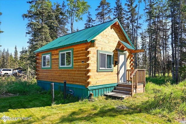 34540 Poppy Wood St, Soldotna, AK 99669 - view of side of home featuring log exterior, a yard, a metal roof, and an outbuilding
