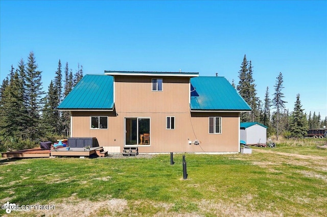 34540 Poppy Wood St, Soldotna, AK 99669 - back of house featuring a wooden deck, a metal roof, and a lawn
