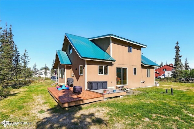 34540 Poppy Wood St, Soldotna, AK 99669 - back of house with a metal roof, a lawn, and a wooden deck