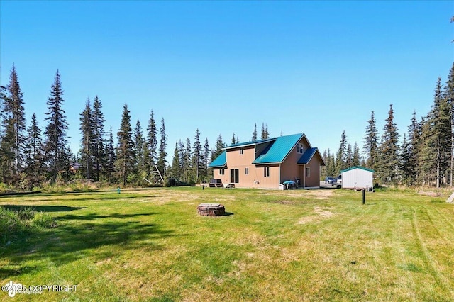 34540 Poppy Wood St, Soldotna, AK 99669 - view of grassy yard featuring a fire pit
