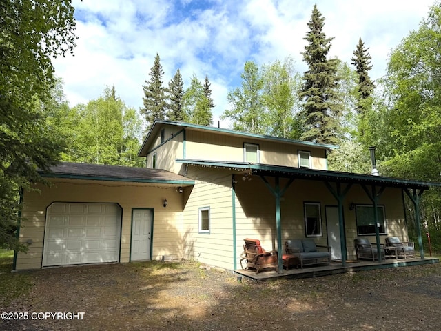 2423 Statehood St, North Pole, AK 99705 - view of front of home featuring an attached garage, driveway, and covered porch