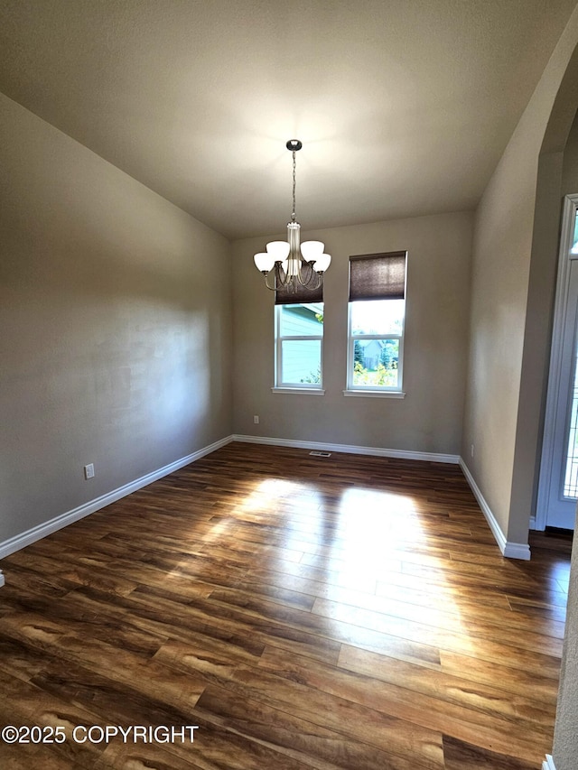 5523 Grand Teton Loop, Anchorage, AK 99502 - unfurnished room featuring a chandelier, wood finished floors, and baseboards