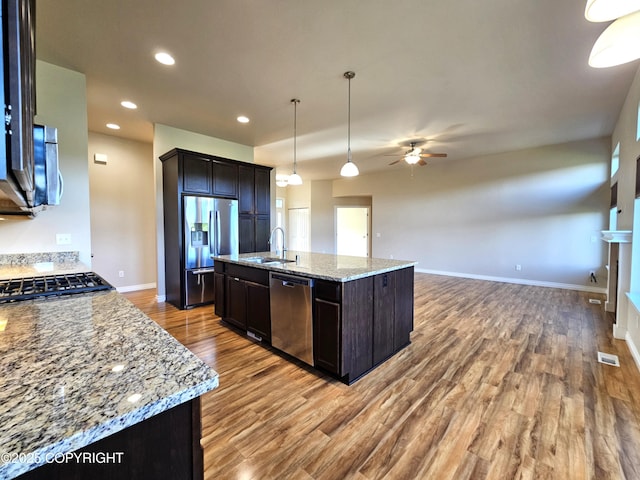 5523 Grand Teton Loop, Anchorage, AK 99502 - kitchen featuring appliances with stainless steel finishes, a ceiling fan, light wood-type flooring, open floor plan, and a sink