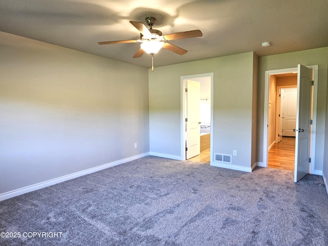 5523 Grand Teton Loop, Anchorage, AK 99502 - unfurnished bedroom with carpet, baseboards, a ceiling fan, and connected bathroom