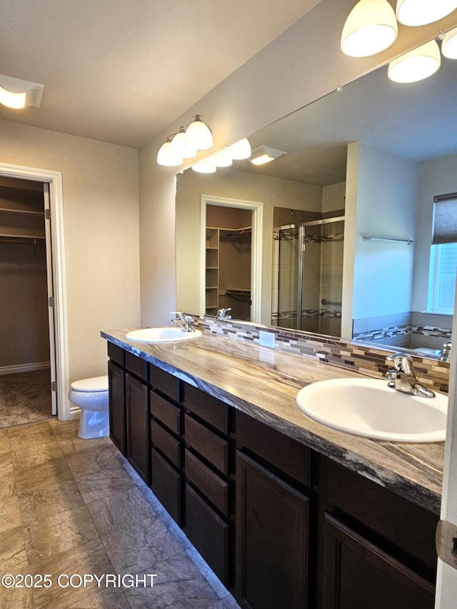 5523 Grand Teton Loop, Anchorage, AK 99502 - full bathroom with a spacious closet, a stall shower, double vanity, and toilet