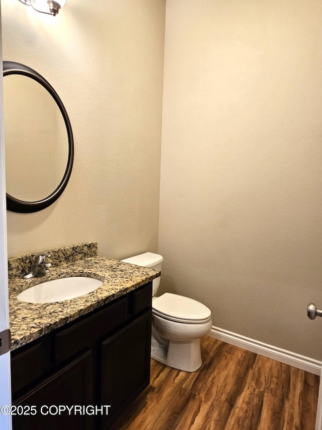 5523 Grand Teton Loop, Anchorage, AK 99502 - half bath featuring vanity, toilet, wood finished floors, and baseboards