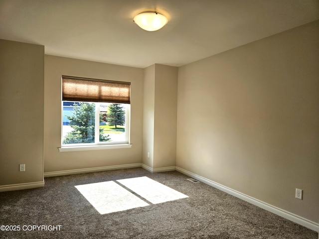 5523 Grand Teton Loop, Anchorage, AK 99502 - spare room featuring carpet floors and baseboards