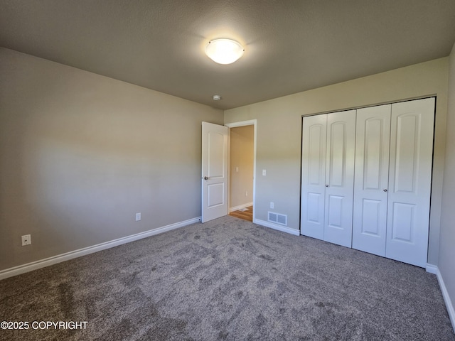 5523 Grand Teton Loop, Anchorage, AK 99502 - unfurnished bedroom with carpet floors, baseboards, and a closet