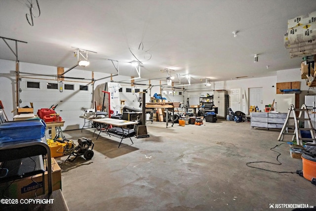 4850 N Riverstone Cir, Palmer, AK 99645 - garage with a workshop area and a garage door opener