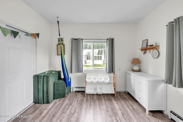 4850 N Riverstone Cir, Palmer, AK 99645 - bedroom featuring baseboard heating and light wood-type flooring