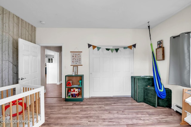 4850 N Riverstone Cir, Palmer, AK 99645 - bedroom with baseboard heating, wood finished floors, and a closet