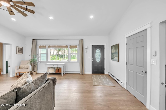 4850 N Riverstone Cir, Palmer, AK 99645 - foyer entrance with a baseboard heating unit, a ceiling fan, vaulted ceiling, baseboard heating, and light wood-type flooring