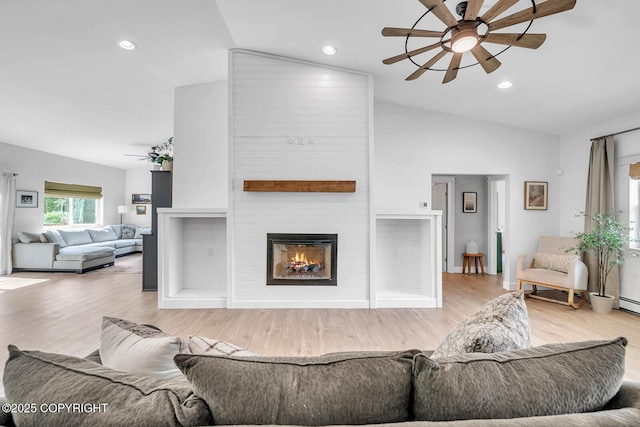 4850 N Riverstone Cir, Palmer, AK 99645 - living room featuring a ceiling fan, lofted ceiling, wood finished floors, a fireplace, and recessed lighting