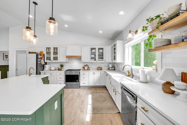 4850 N Riverstone Cir, Palmer, AK 99645 - kitchen featuring stainless steel appliances, a sink, custom exhaust hood, lofted ceiling, and light wood finished floors