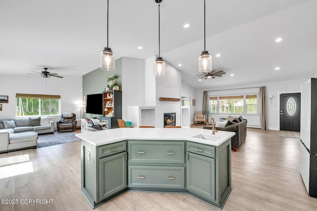 4850 N Riverstone Cir, Palmer, AK 99645 - kitchen featuring ceiling fan, green cabinetry, open floor plan, a fireplace, and vaulted ceiling