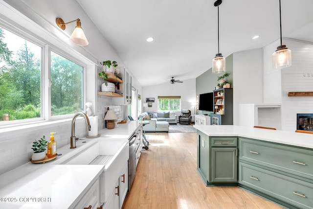 4850 N Riverstone Cir, Palmer, AK 99645 - kitchen with green cabinetry, ceiling fan, light countertops, light wood-style flooring, and lofted ceiling