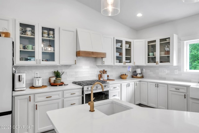 4850 N Riverstone Cir, Palmer, AK 99645 - kitchen with custom exhaust hood, stainless steel range with gas stovetop, white cabinets, backsplash, and recessed lighting