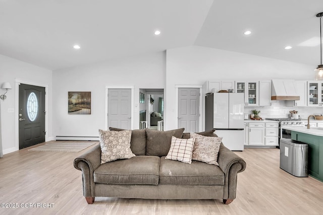 4850 N Riverstone Cir, Palmer, AK 99645 - living room featuring light wood finished floors, baseboard heating, recessed lighting, high vaulted ceiling, and baseboards