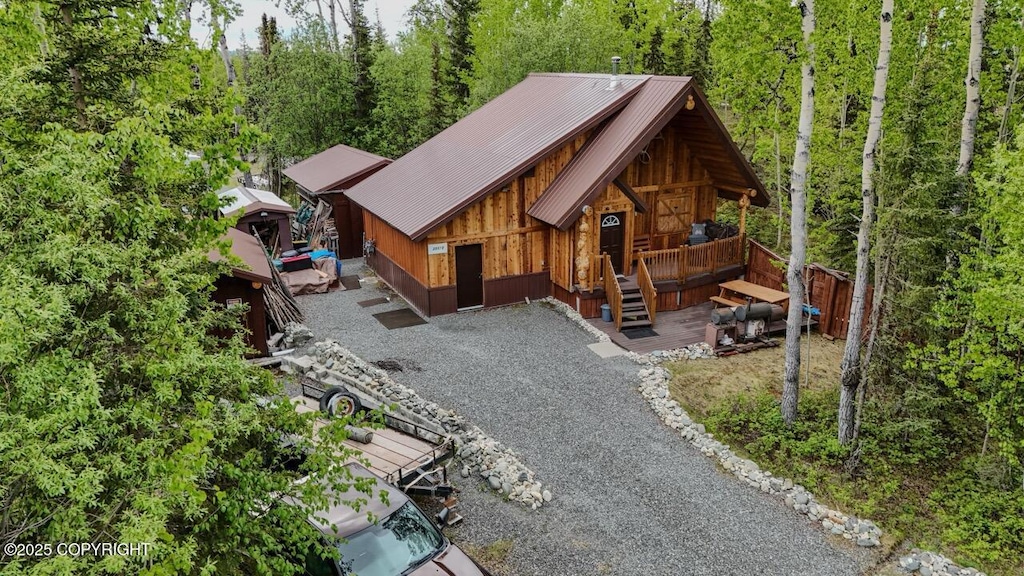 30175 Wildlife Ave, Sterling, AK 99672 - view of front of home featuring metal roof, driveway, a view of trees, and a porch