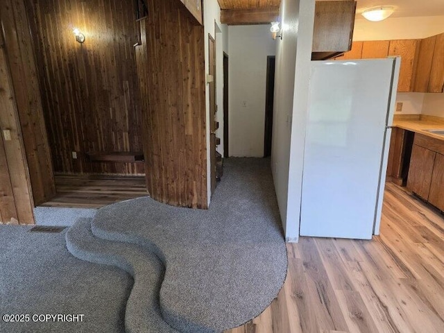 5650 N Talgach View Dr, Wasilla, AK 99654 - kitchen featuring freestanding refrigerator, brown cabinets, light wood-style flooring, and light countertops
