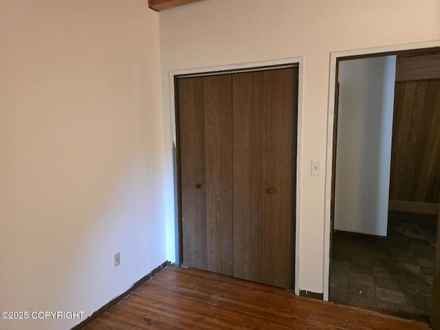 5650 N Talgach View Dr, Wasilla, AK 99654 - unfurnished bedroom featuring a closet and dark wood-type flooring