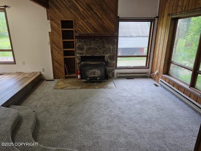 5650 N Talgach View Dr, Wasilla, AK 99654 - unfurnished living room with wooden walls, healthy amount of natural light, and carpet floors