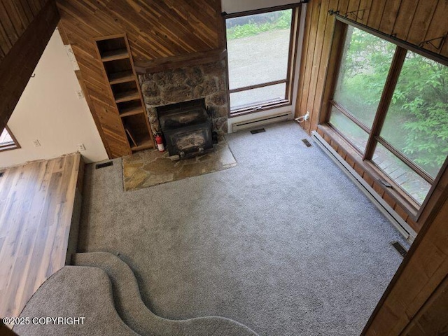 5650 N Talgach View Dr, Wasilla, AK 99654 - unfurnished living room featuring wood walls, plenty of natural light, carpet, wooden ceiling, and lofted ceiling