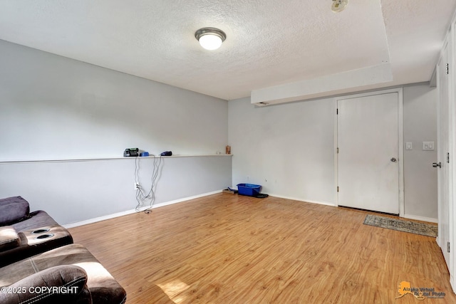 3040 Rosalind Loop, Anchorage, AK 99507 - unfurnished room with wood finished floors, a textured ceiling, and baseboards
