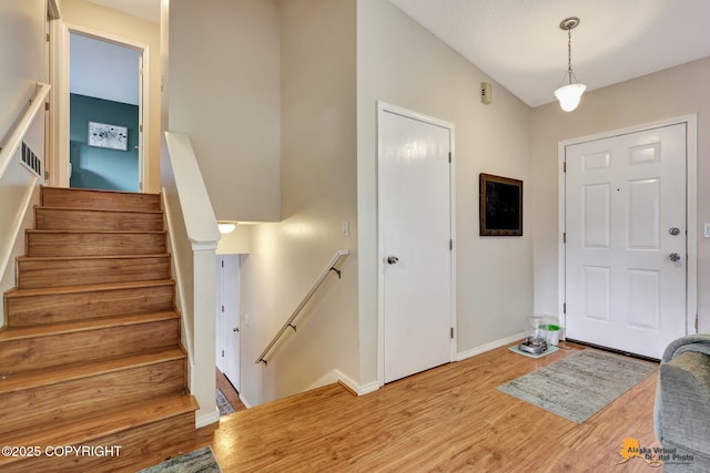 3040 Rosalind Loop, Anchorage, AK 99507 - entrance foyer with wood finished floors, baseboards, and stairway