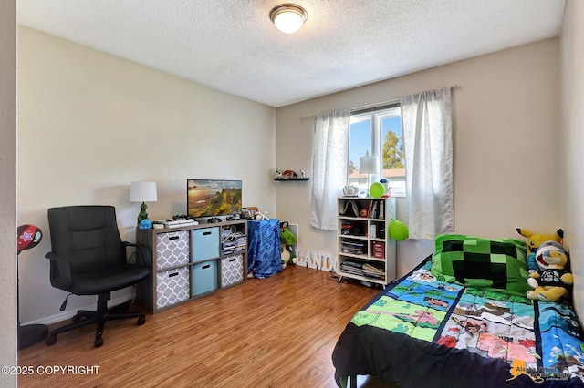 3040 Rosalind Loop, Anchorage, AK 99507 - bedroom with wood finished floors, a textured ceiling, and baseboards