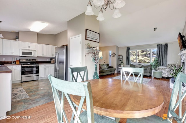 3040 Rosalind Loop, Anchorage, AK 99507 - dining area with a chandelier and light wood-style floors
