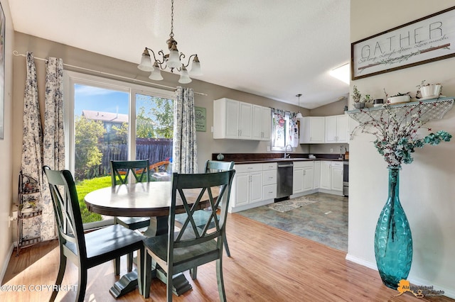 3040 Rosalind Loop, Anchorage, AK 99507 - dining space with a chandelier, light wood-type flooring, vaulted ceiling, baseboards, and a textured ceiling