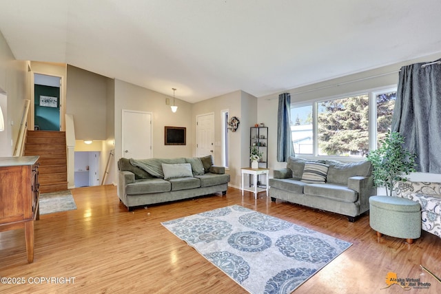 3040 Rosalind Loop, Anchorage, AK 99507 - living area with lofted ceiling, wood finished floors, and stairway