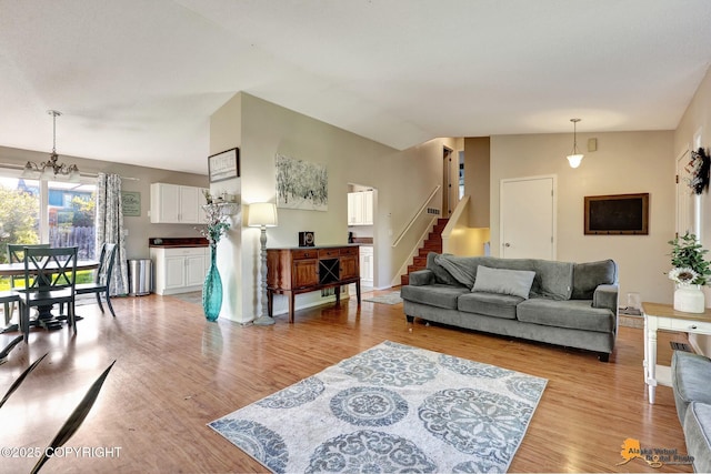 3040 Rosalind Loop, Anchorage, AK 99507 - living room with light wood finished floors, stairs, and a chandelier