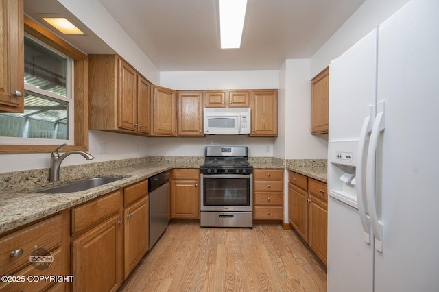13311 Cove Cir, Anchorage, AK 99515 - kitchen featuring stainless steel appliances, light wood finished floors, brown cabinetry, and light stone counters