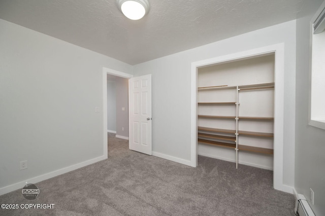 13311 Cove Cir, Anchorage, AK 99515 - unfurnished bedroom featuring carpet flooring, baseboard heating, a closet, and a textured ceiling