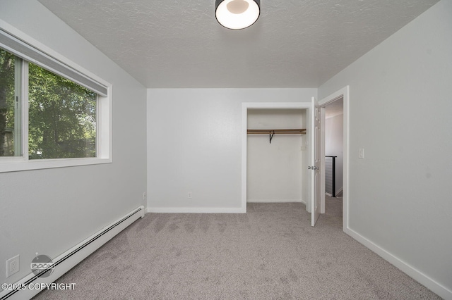 13311 Cove Cir, Anchorage, AK 99515 - unfurnished bedroom with a baseboard radiator, carpet, a textured ceiling, and a closet