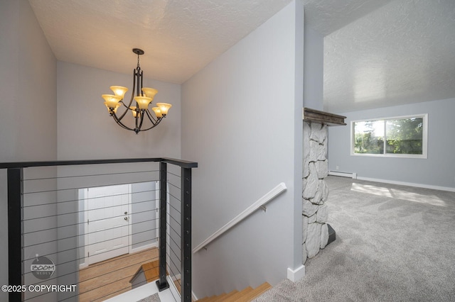 13311 Cove Cir, Anchorage, AK 99515 - stairs with a chandelier, a textured ceiling, carpet flooring, and a baseboard heating unit