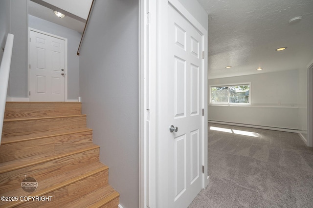 13311 Cove Cir, Anchorage, AK 99515 - staircase with a baseboard heating unit, carpet floors, a textured ceiling, and recessed lighting