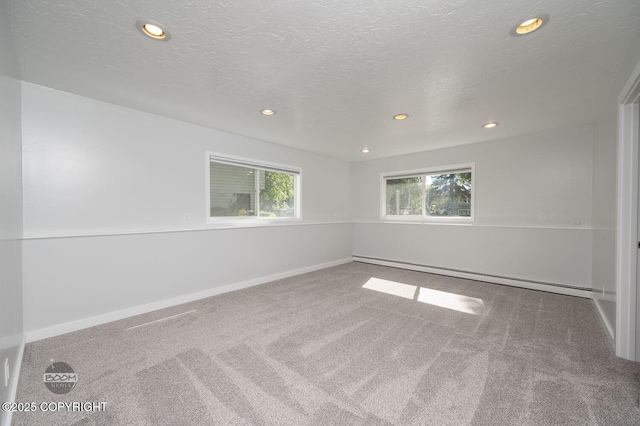 13311 Cove Cir, Anchorage, AK 99515 - spare room with baseboard heating, recessed lighting, carpet floors, and a textured ceiling