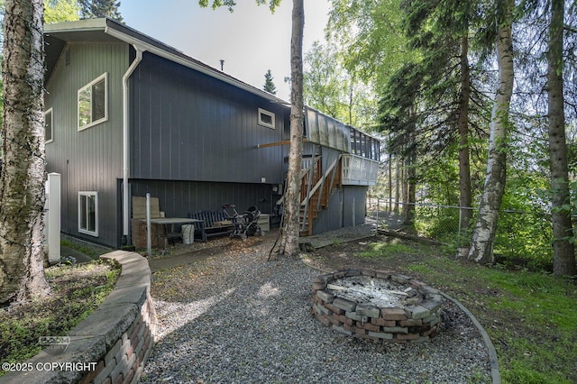 13311 Cove Cir, Anchorage, AK 99515 - rear view of house featuring stairway and a fire pit